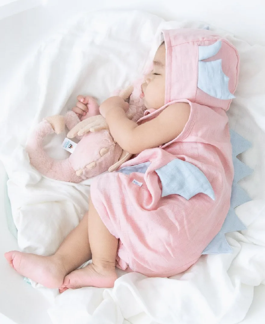 Baby in a pink dragon romper